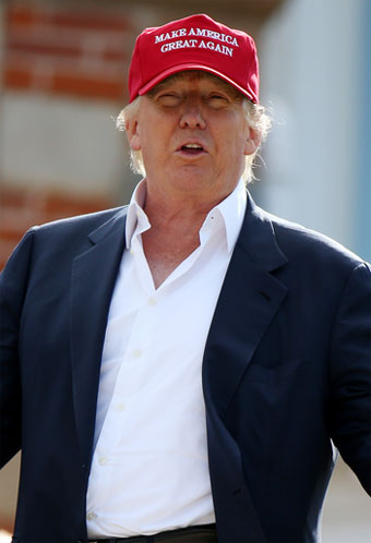 Donald J. Trump, potential leader of the first toolbagocgracy, in casualwear look that's winning with voters: open collar shirt, blazer, legible baseball cap.